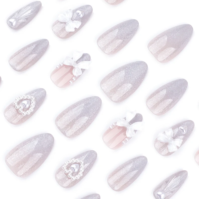 Artful nail decoration with pearl and bow accents Stornfield