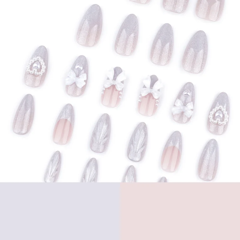 Artful nail decoration with pearl and bow accents Stornfield