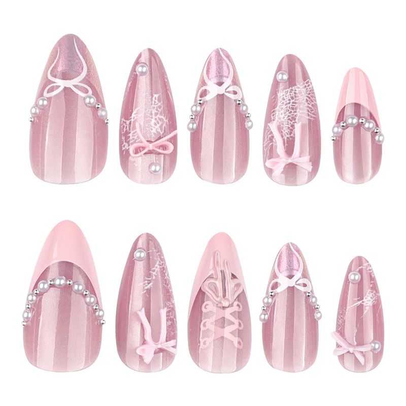 Artful nail extensions with delicate bow motifs Stornfield
