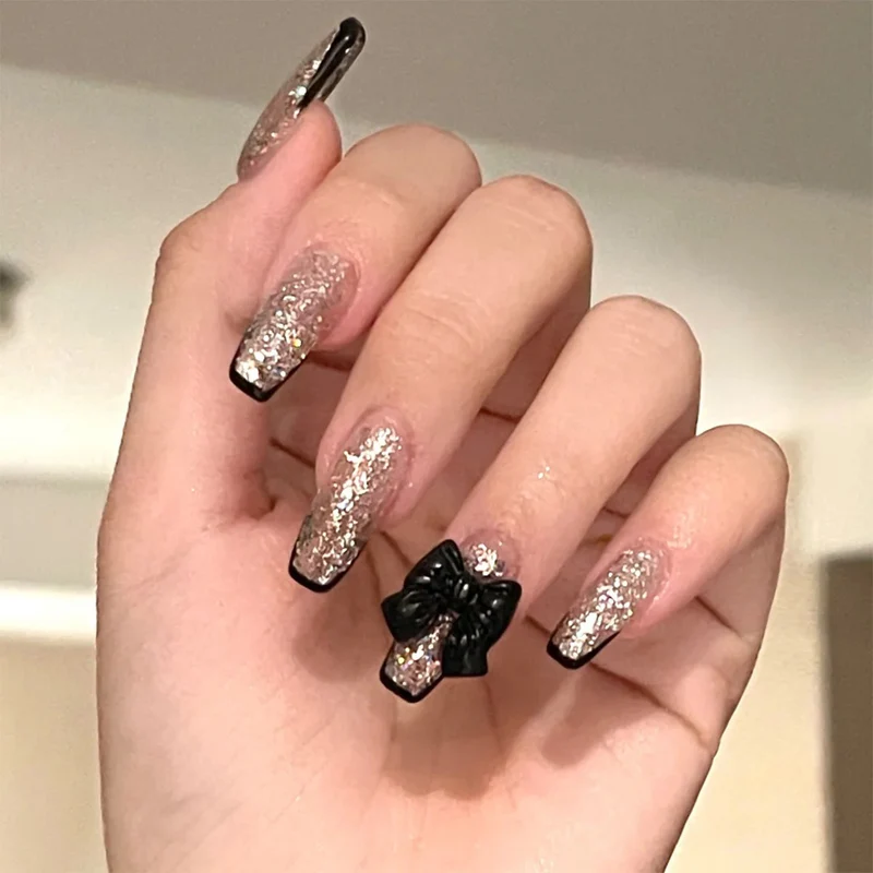 Artistic Nail Extensions with Glitter and Bow Accents Stornfield