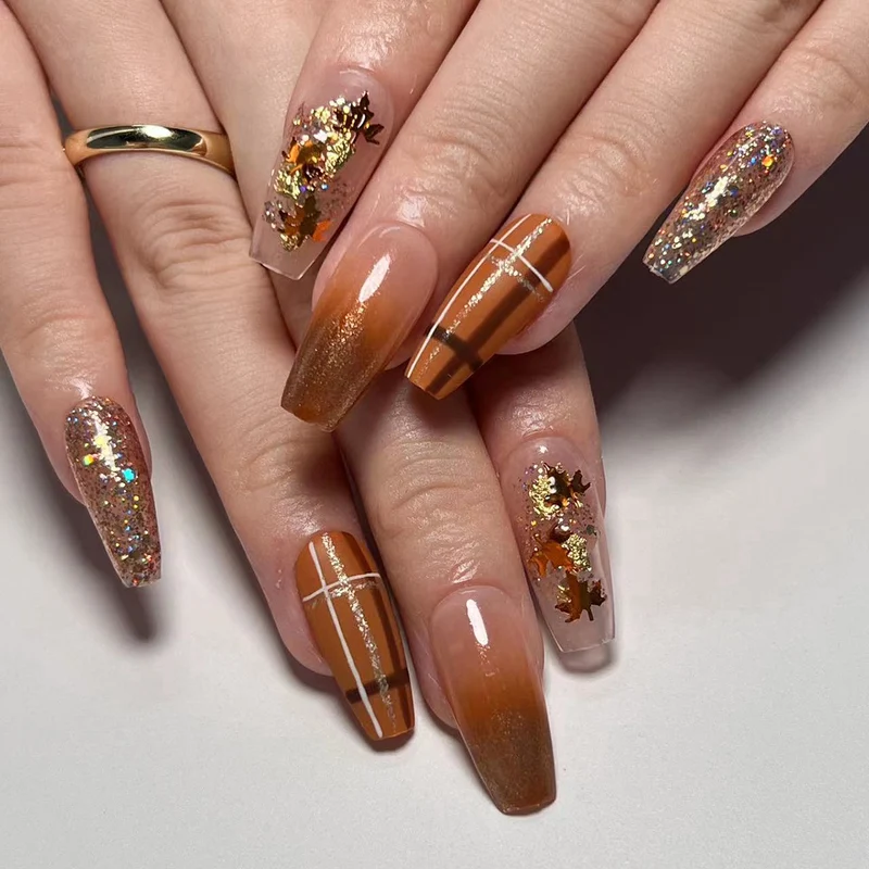 Artful nail extensions with glitter and leaf patterns Stornfield