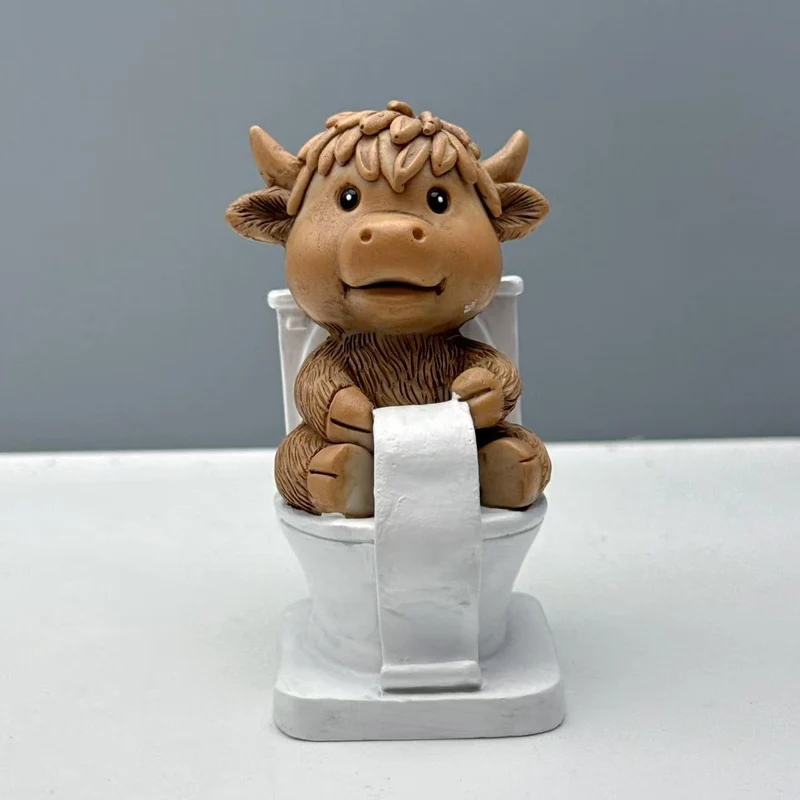 Funny decorative figure of a Highland cow on toilet Stornfield