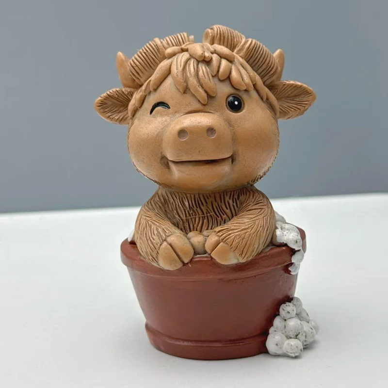 Funny decorative figure of a Highland cow on toilet Stornfield