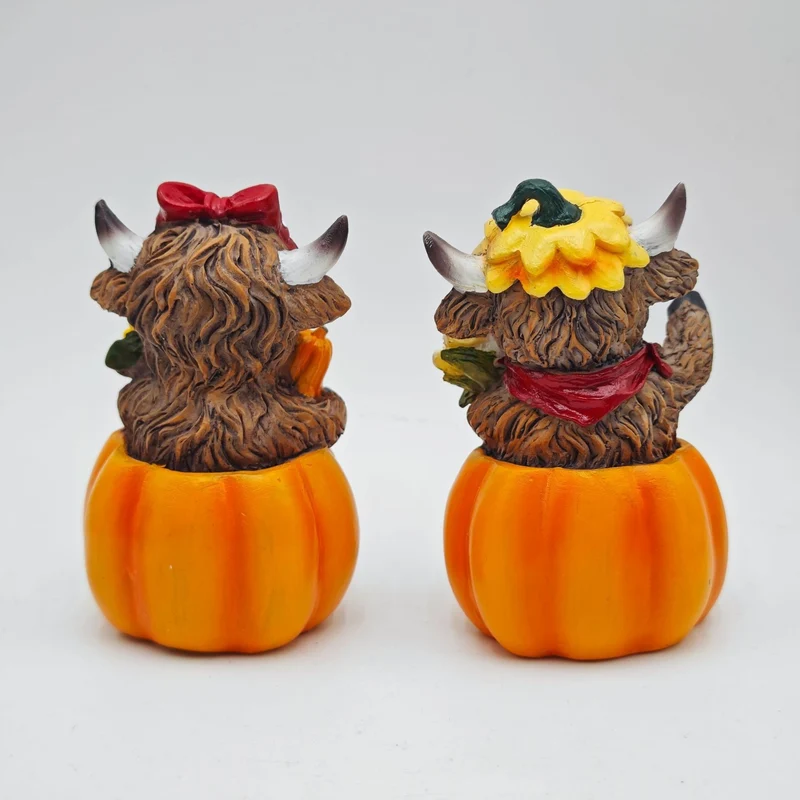 Funny decorative figure of a Highland cow in pumpkin costume Stornfield