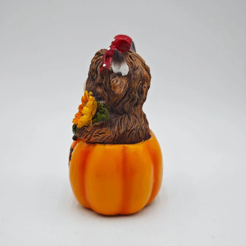 Funny decorative figure of a Highland cow in pumpkin costume Stornfield