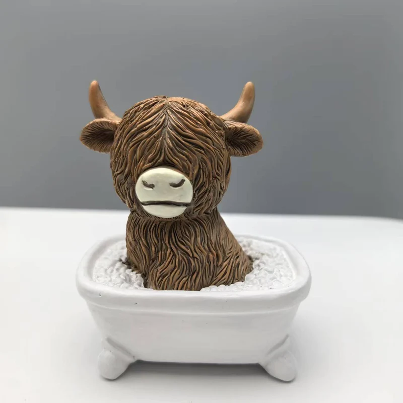 Funny decorative figure of a Highland cow in a bathtub Stornfield