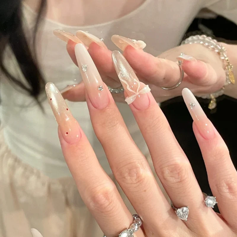 Elegante Stiletto Press-On Nägel mit dekorativem Bogen und Strassakzenten Karnz