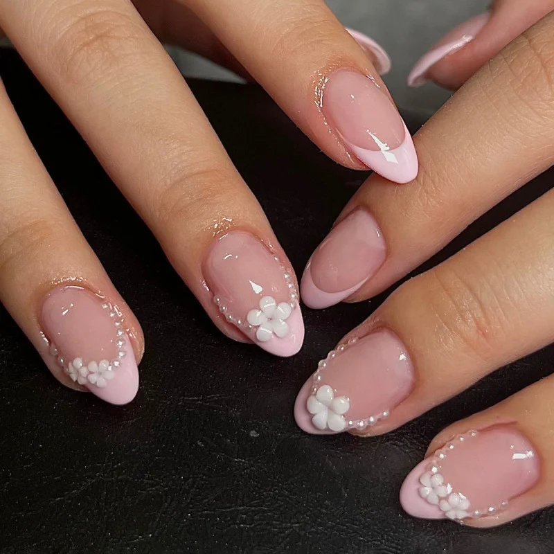 Kunstvolle Nagelkunst mit Blumen-Design und Blauem French Tip Karnz