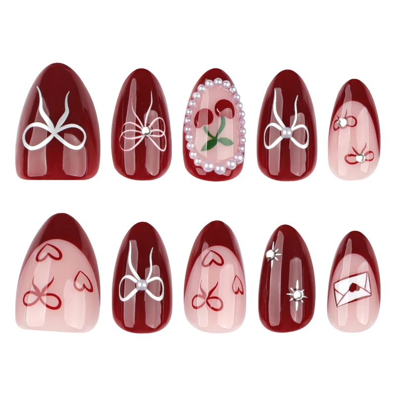 Kunstvolle Nageldesigns mit Schleifen- und Rosenmotiv Karnz