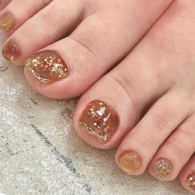 Kunstvolle Fußnagelverzierung mit elegantem Goldakzent Karnz