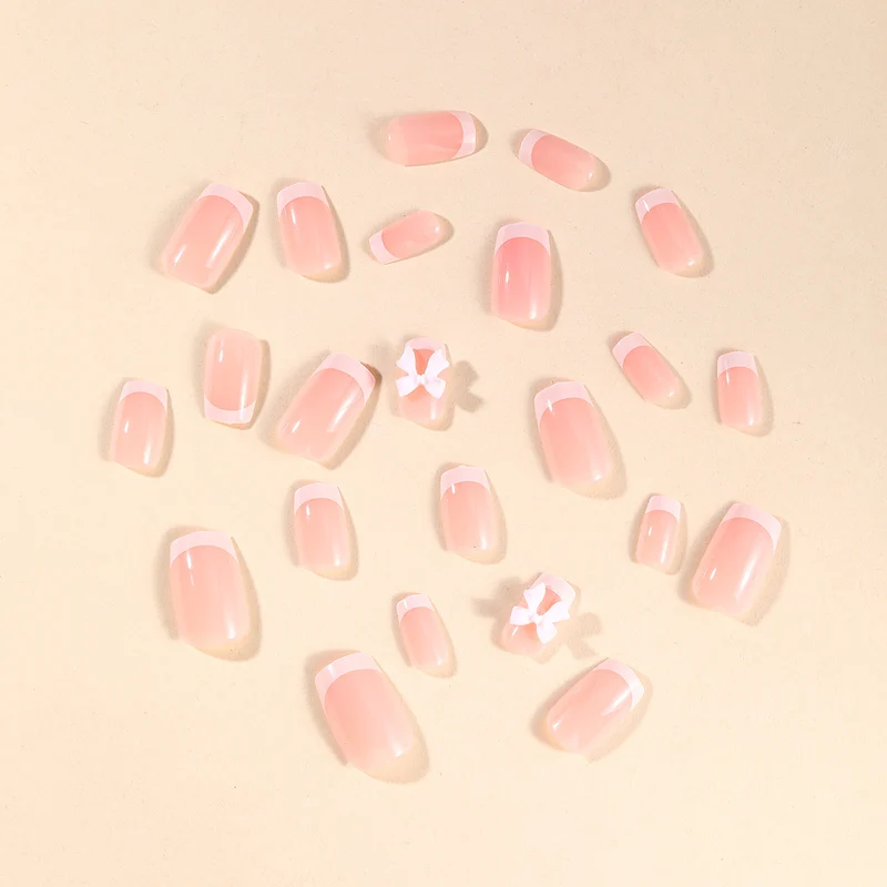 Elegant French Tip Nail Art with Bow Embellishments Stornfield
