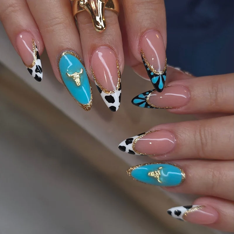 Artistic Stiletto Nail Art Extensions with Cow Print and Gold Accents Stornfield