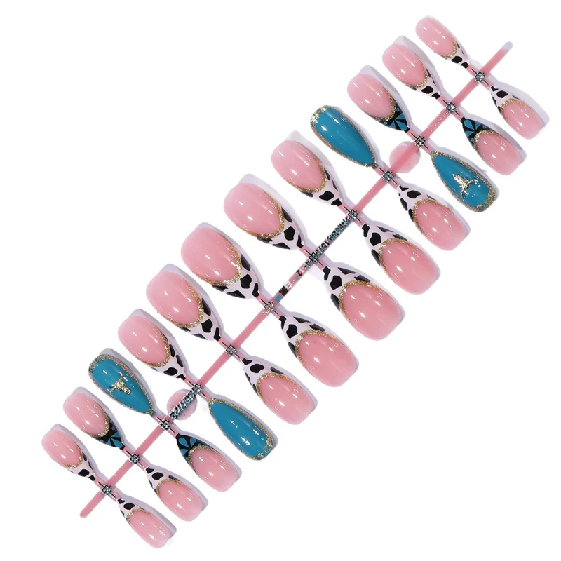 Artistic Stiletto Nail Art Extensions with Cow Print and Gold Accents Stornfield