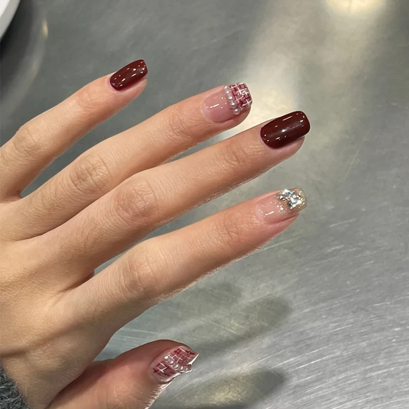 Elegant Press-On Nail Design with Glitter and Gemstone Accents Stornfield