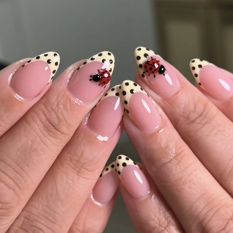 Artful nail art with ladybug motif and polka dots Stornfield