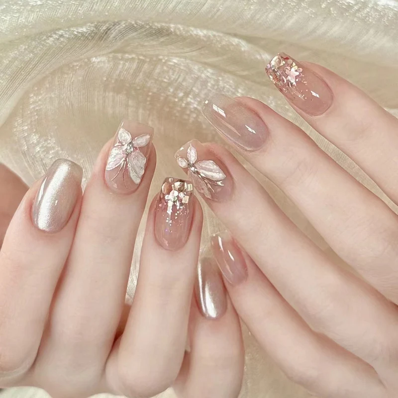 Artful nail art with butterfly designs and glitter accents Stornfield