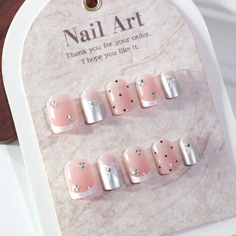 Artistic Nail Art with Bow and Glitter Accents Stornfield