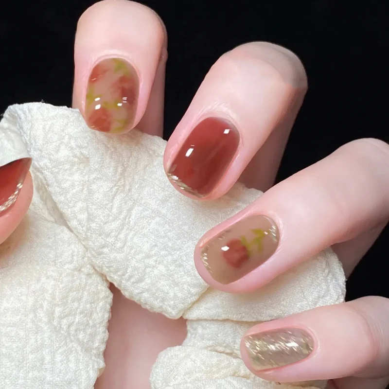 Artful nail art with natural gradient and floral accents Stornfield