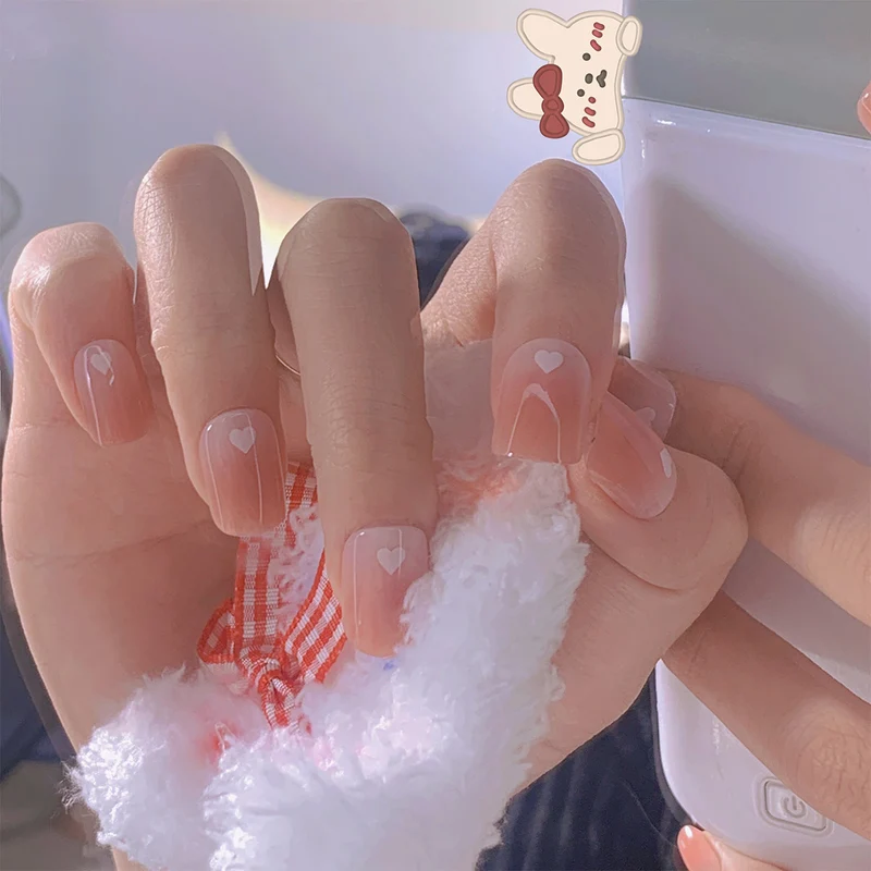 Artful nail art with heart-shaped accents and gentle ombre effect Stornfield