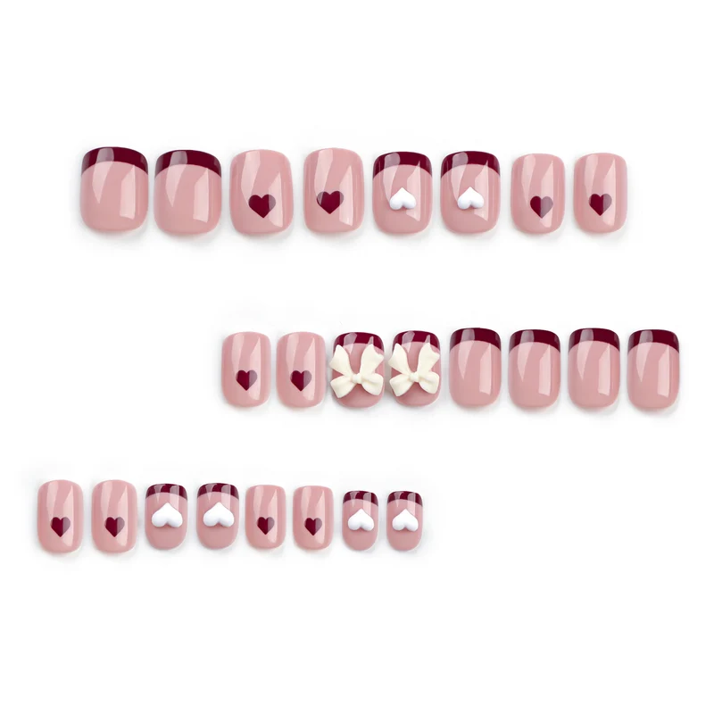 Artful nail art with heart and bow motifs Stornfield