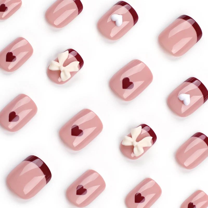 Artful nail art with heart and bow motifs Stornfield