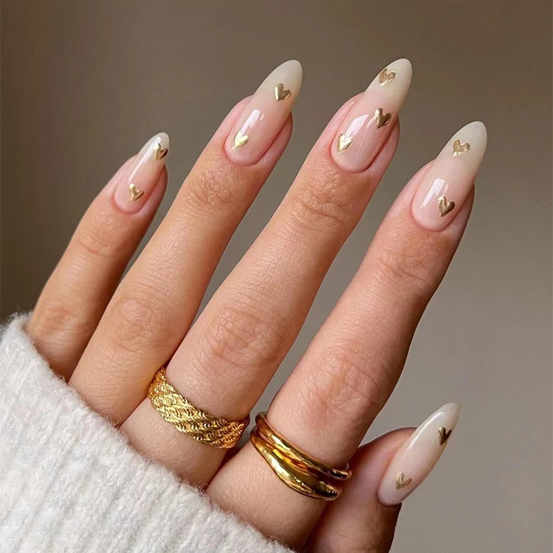Artful Nail Art with Golden Heart Accents Stornfield