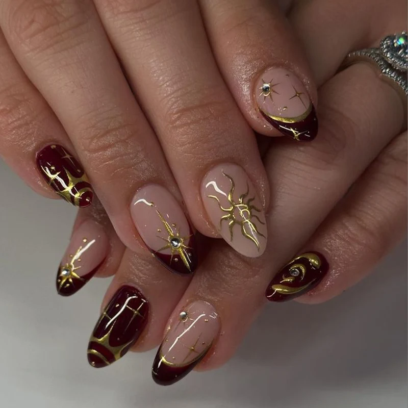 Artful nail art with golden accents and mystical motifs Stornfield