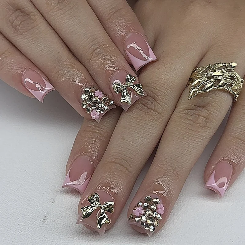 Artful nail art with glitter accents and bow decoration Stornfield