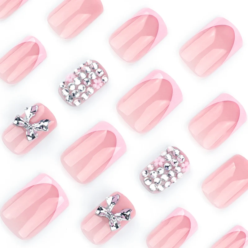 Artful nail art with glitter accents and bow decoration Stornfield