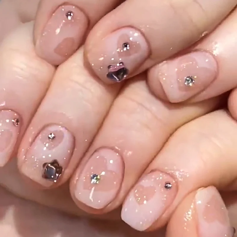 Artistic Nail Art with Glitter and Heart Designs Stornfield