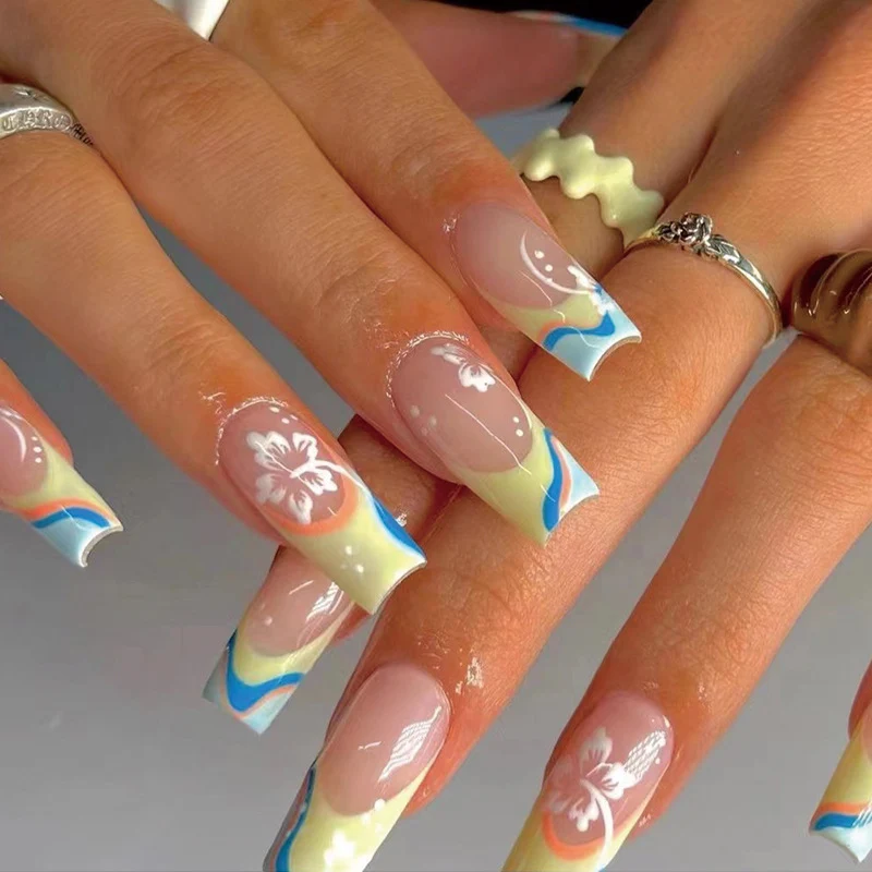 Artistic nail art with floral accents and creative color layers Stornfield
