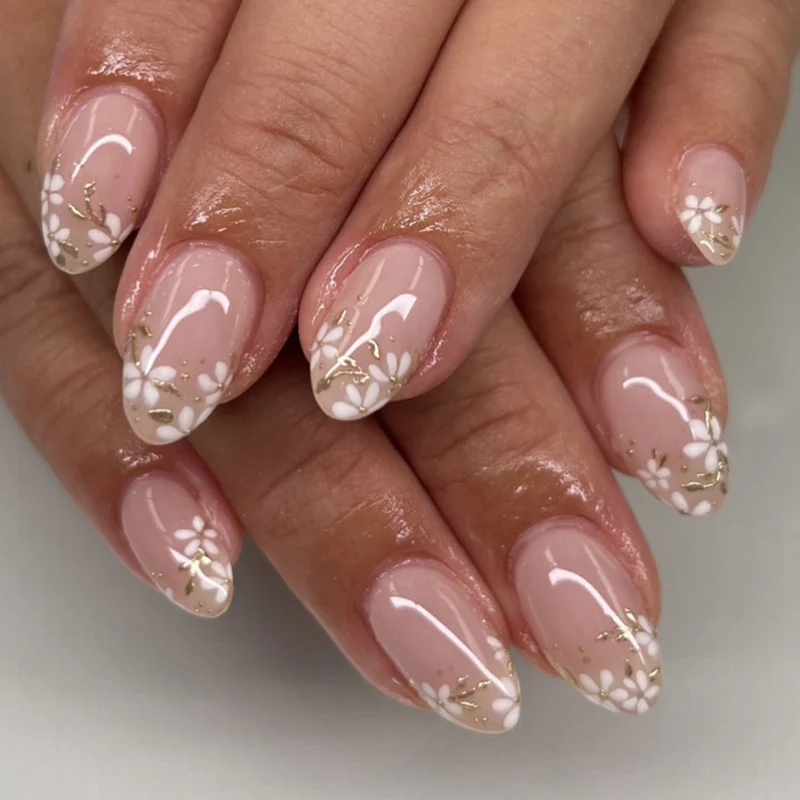 Artful nail art with floral design and glitter accents Stornfield