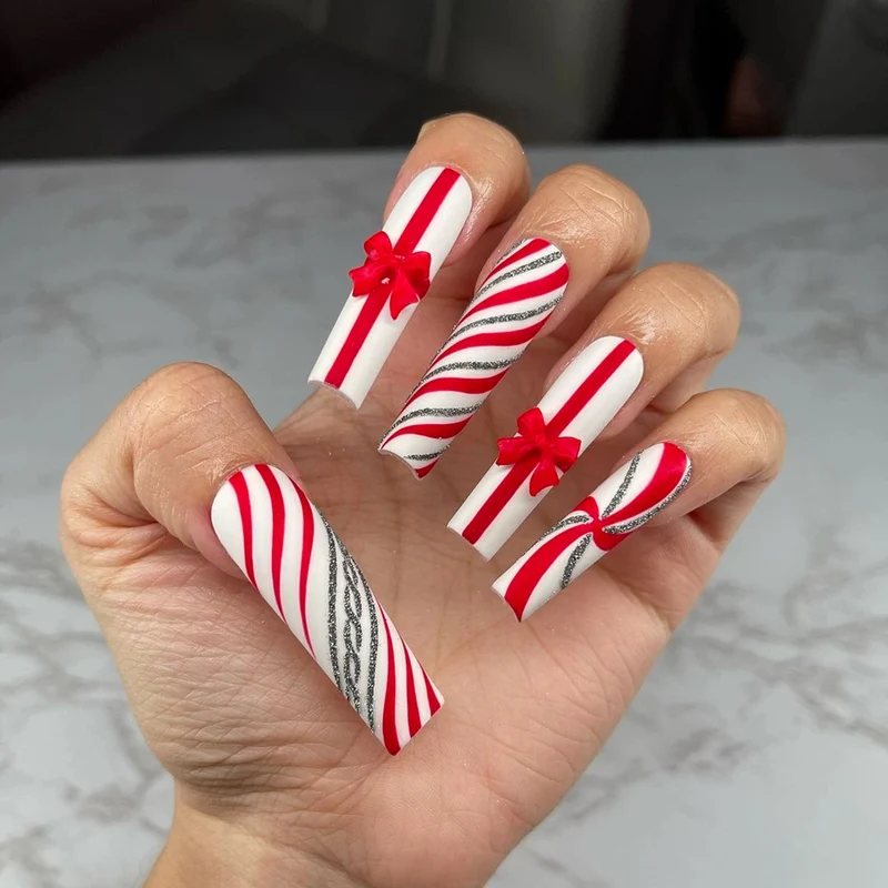 Artful Nail Art with Festive Bows and Christmas Motifs Stornfield