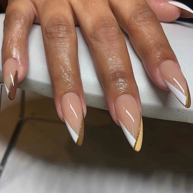 Artful nail art in elegant stiletto design with golden accents Stornfield