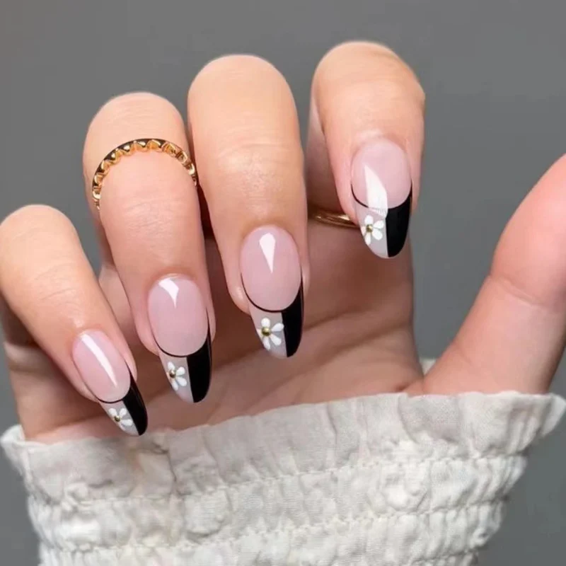 Artful nail art with elegant black-and-white design and floral accents Stornfield