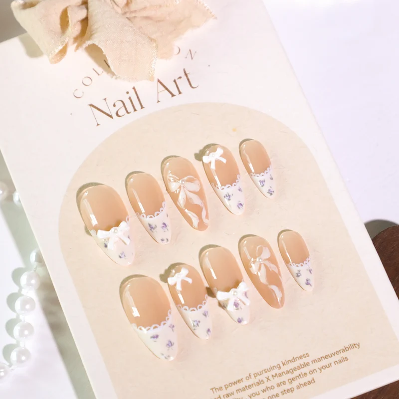 Artful nail art with elegant bows and rhinestone details Stornfield