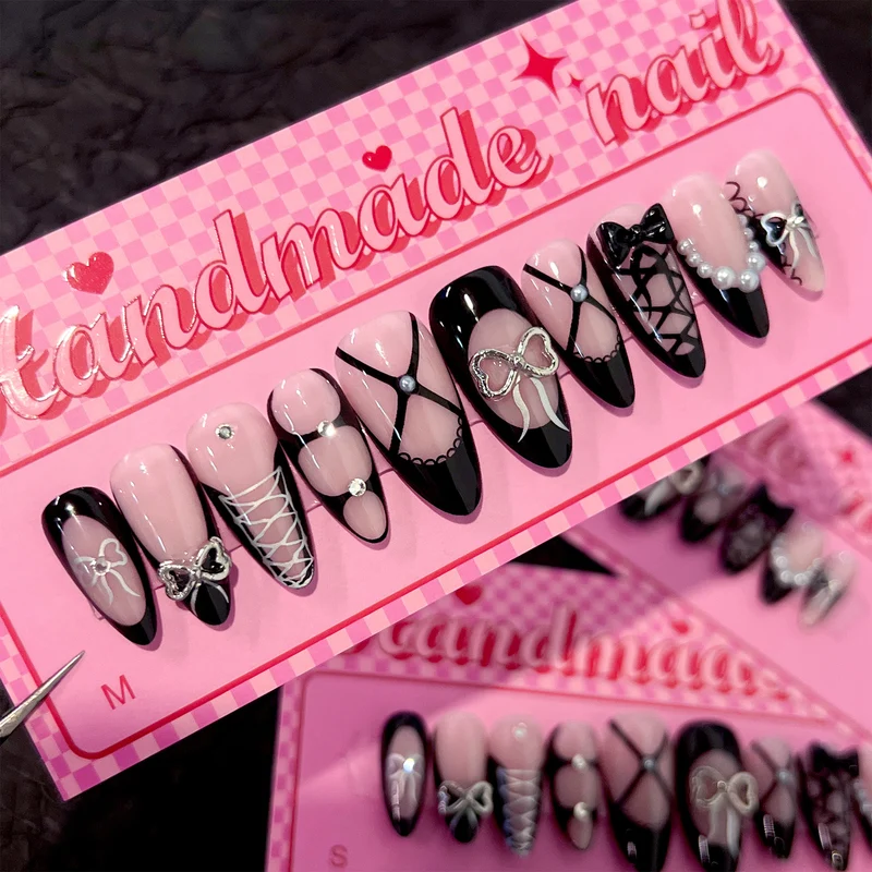 Artful nail art with elegant bows and glitter accents Stornfield