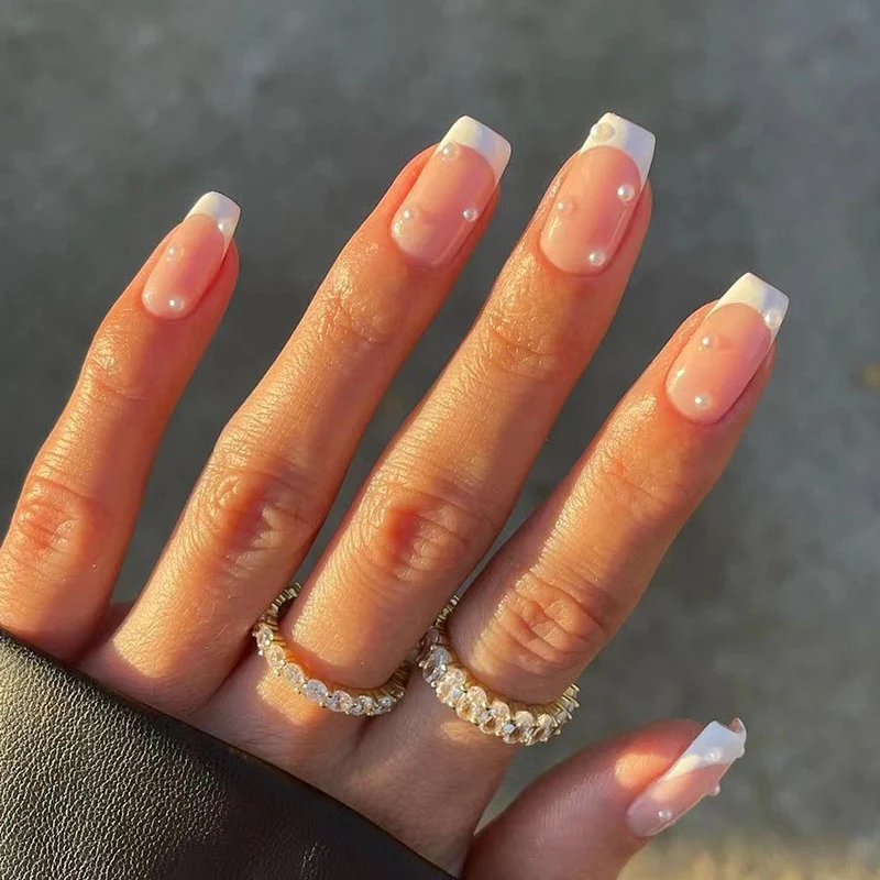 Artful nail art with elegant pearl and glitter accents Stornfield