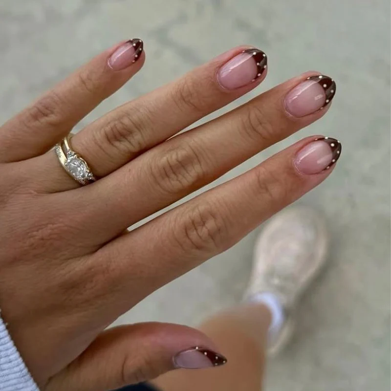 Artful nail art with elegant French tips and glitter accents Stornfield