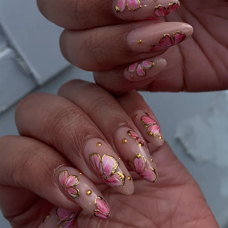 Artful nail art with elegant floral designs and gold accents Stornfield