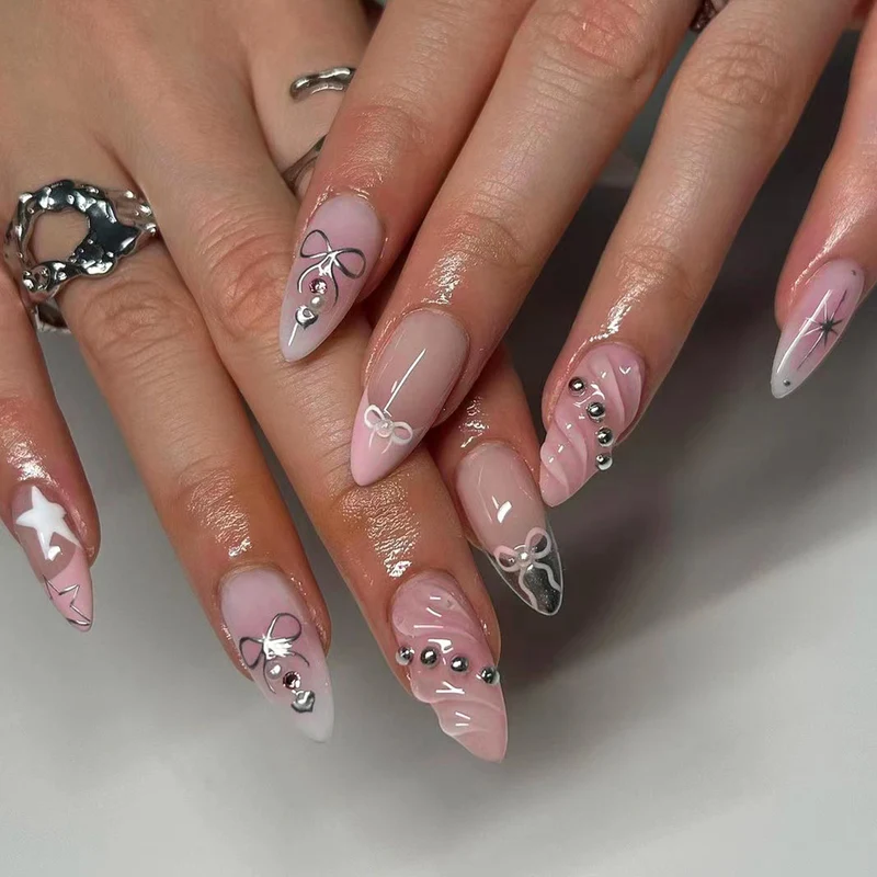 Artistic Nail Art with decorative bows and glitter accents Stornfield