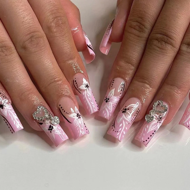 Artistic nail art with flower and heart motifs Stornfield