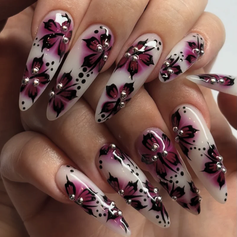 Artful nail art with floral design and rhinestone accents Stornfield