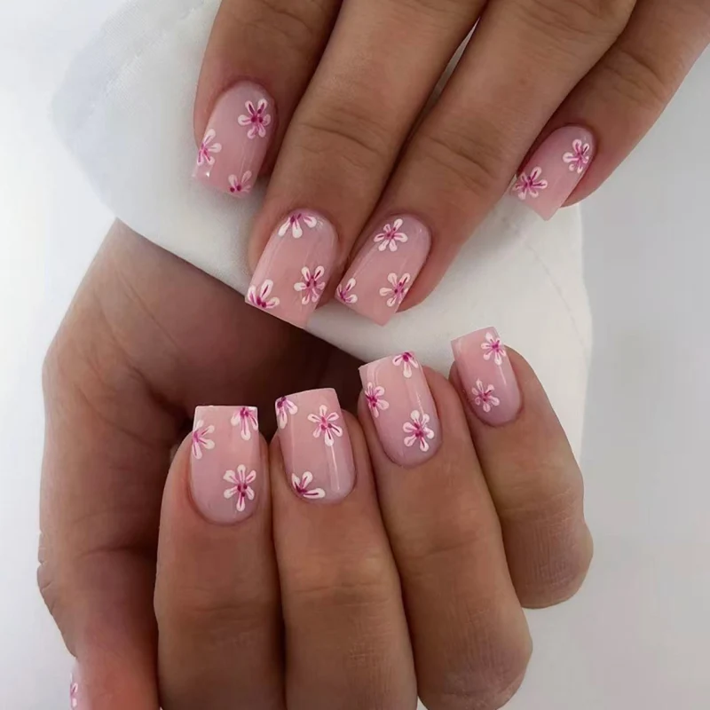 Artful Nail Art with Flower Design and Blue French Tip Stornfield