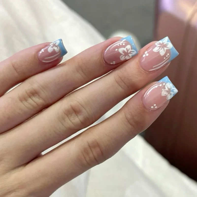 Artful Nail Art with Flower Design and Blue French Tip Stornfield