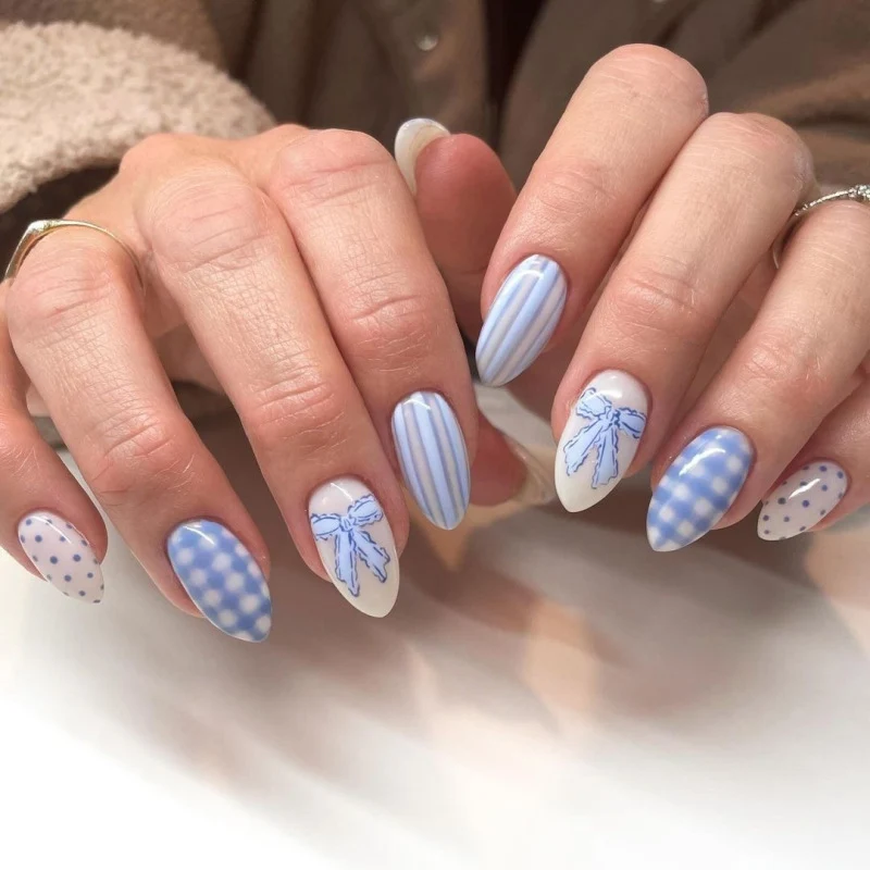 Artful Nail Art with Flower Design and Blue French Tip Stornfield