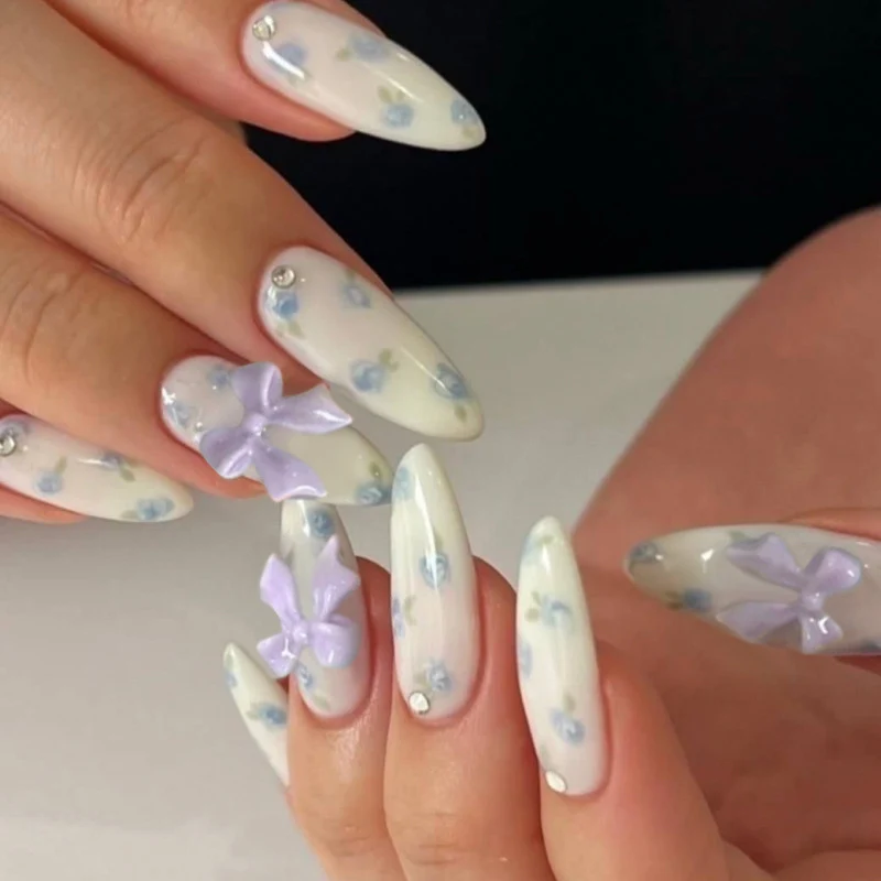 Artful Nail Art with Flower Design and Blue French Tip Stornfield
