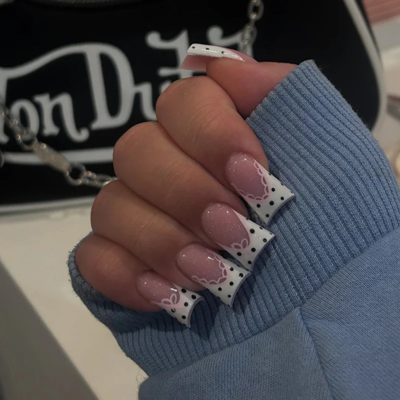 Artful Nail Art with Flower Design and Blue French Tip Stornfield