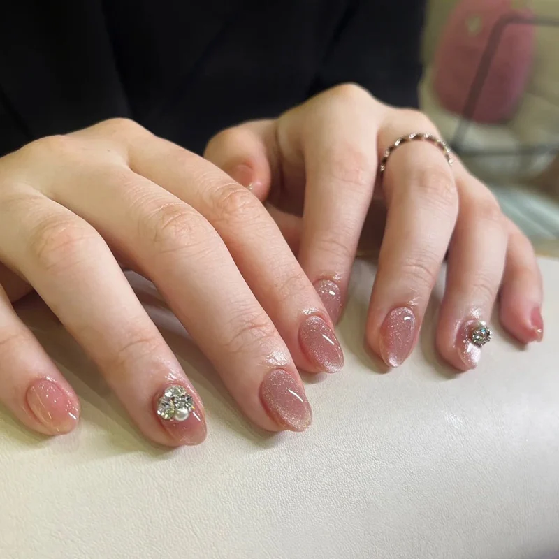 Artful glitter nail extensions with elegant rhinestone accents Stornfield