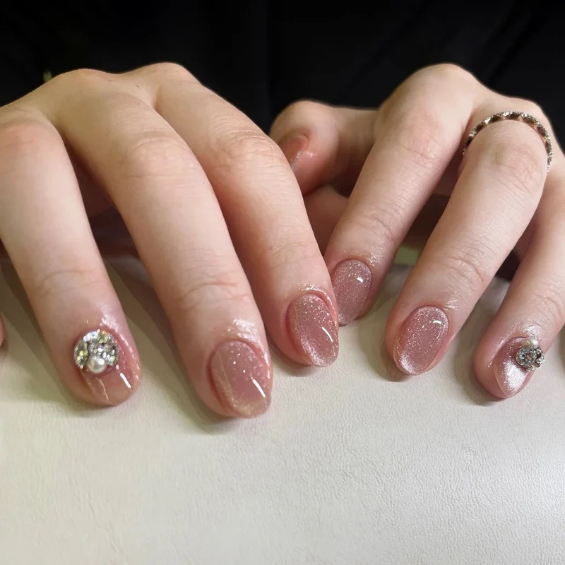 Artful glitter nail extensions with elegant rhinestone accents Stornfield
